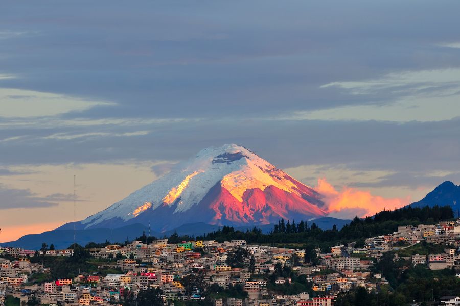 Image of Ecuador with a beautiful mountain/ volcano and colourful houses. 