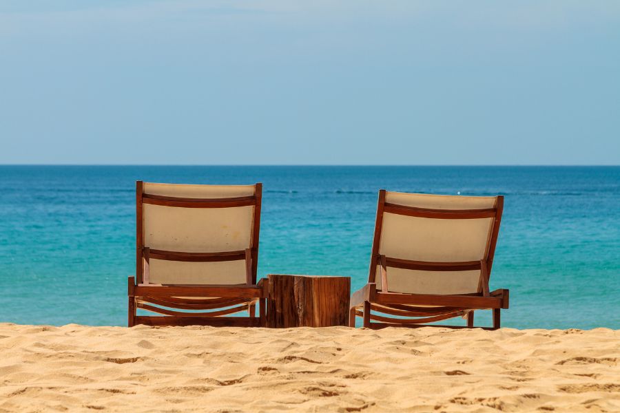 Two empty chairs on the beach