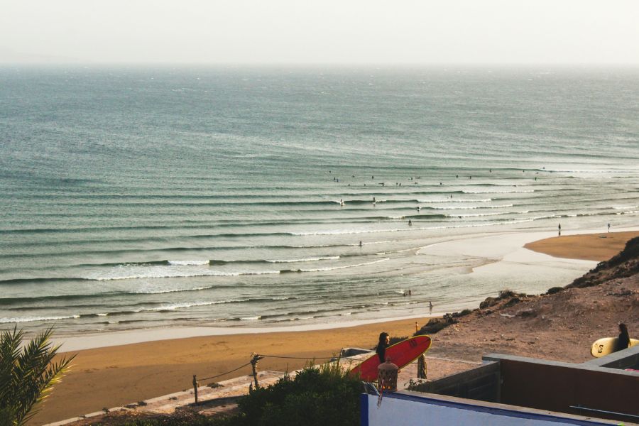 Imsouane beach with people surfing 